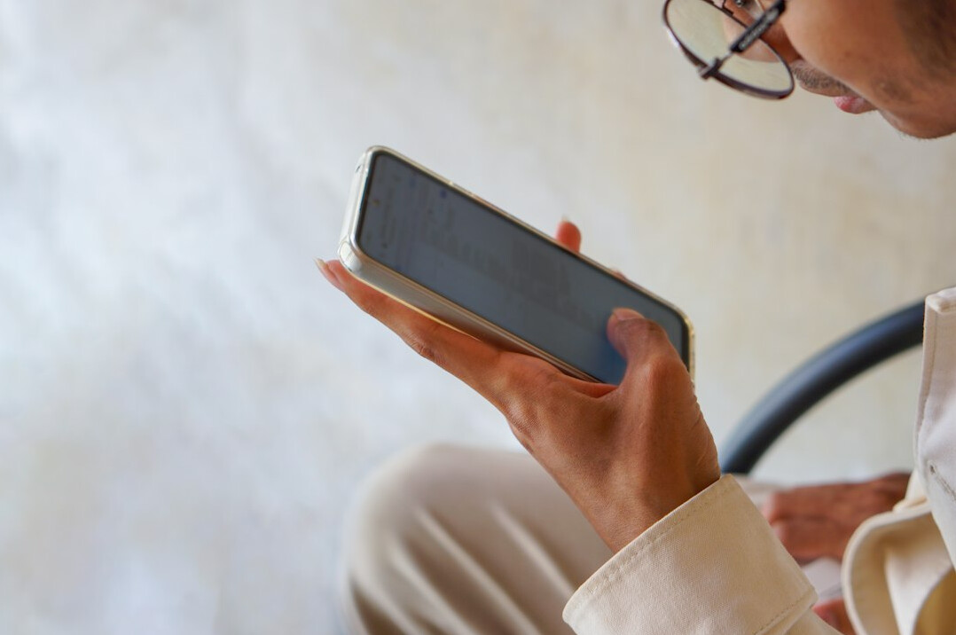 person scrolling phone news